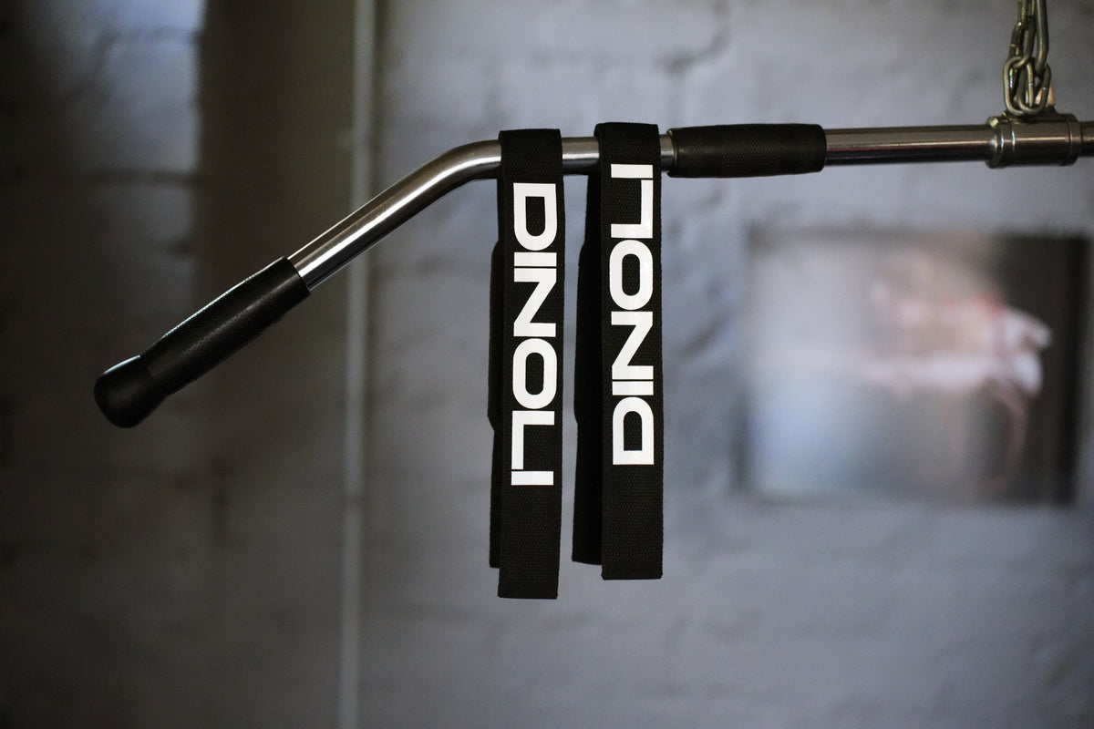 DINOLI Auto-Lock Lifting Straps hanging on a gym cable machine